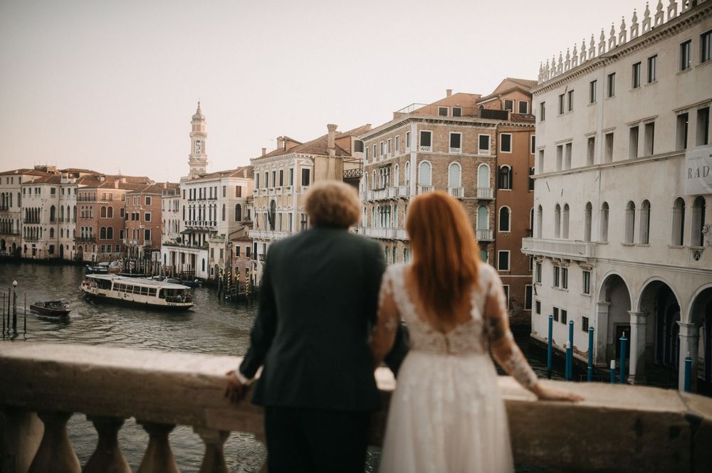 Romantic post-wedding photoshoot along Venice's iconic canal with classic architecture.