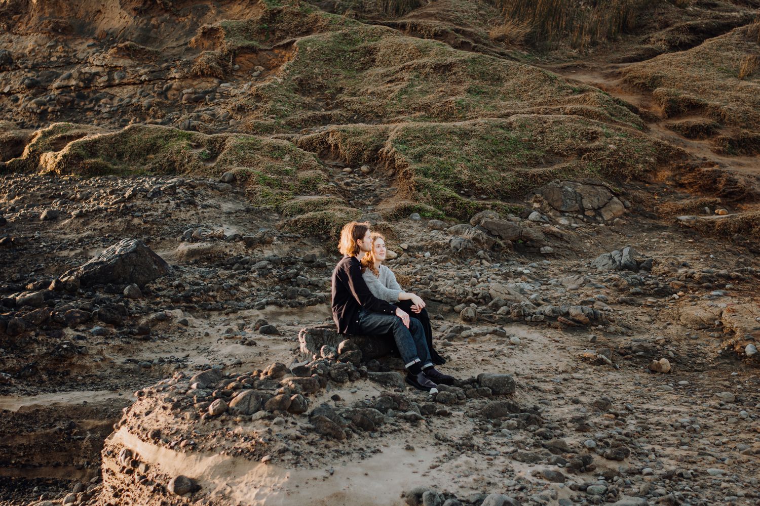 A couple chatting in an engagement shoot in Piha with Apertured Media-Auckland Wedding and Elopement Photographer