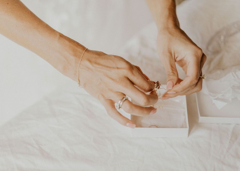 Bride picks out what jewelry to wear for her wedding