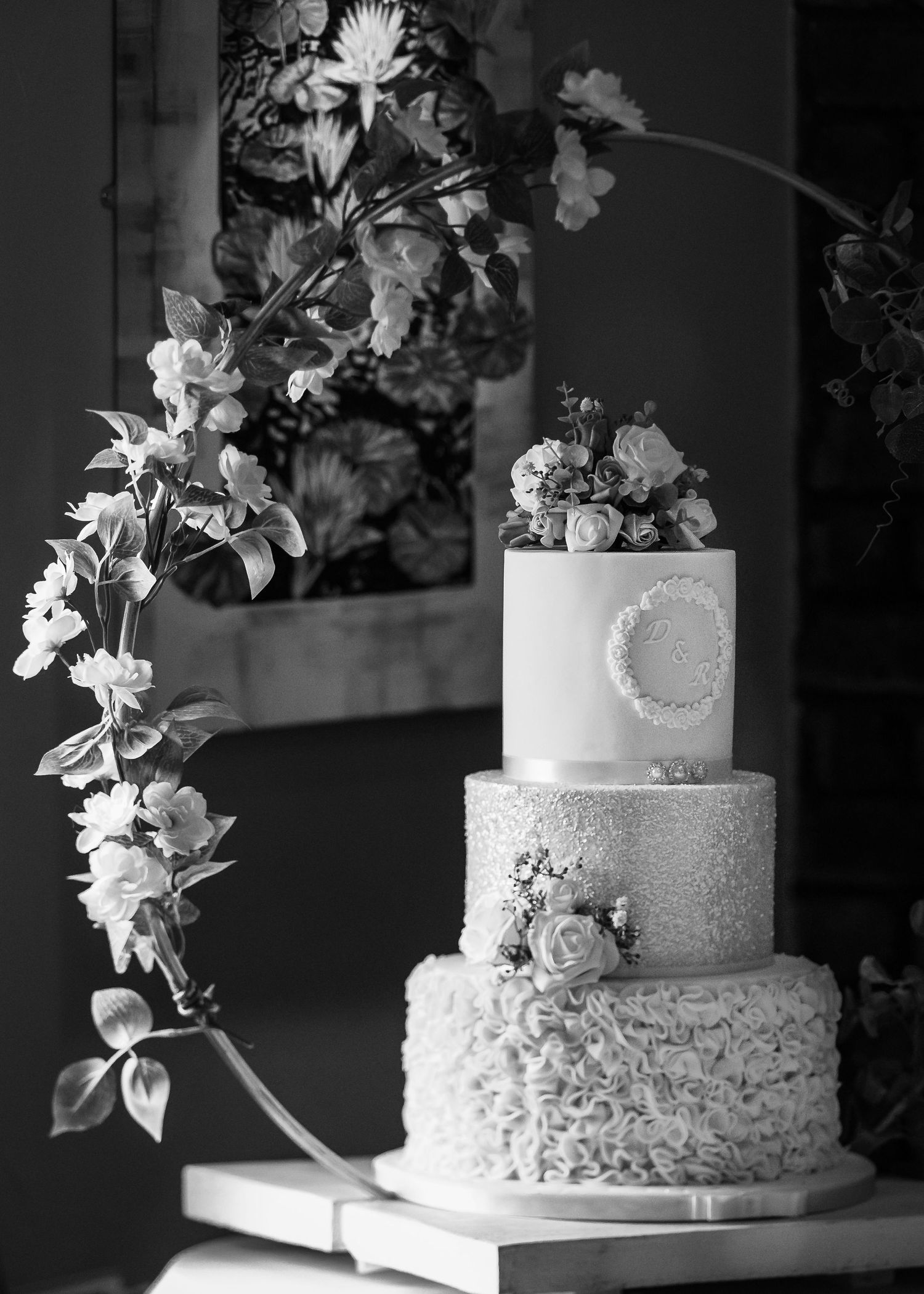 Wedding cake lit from the side by a window as the sun comes in through the window