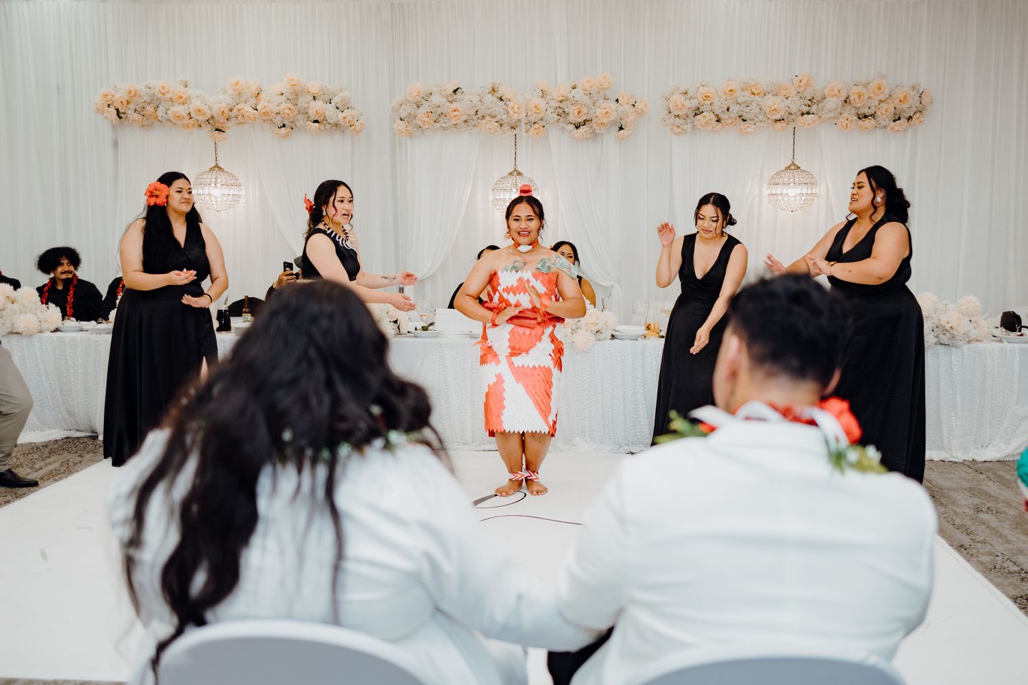 Wedding reception performance featuring dancers in formal attire.