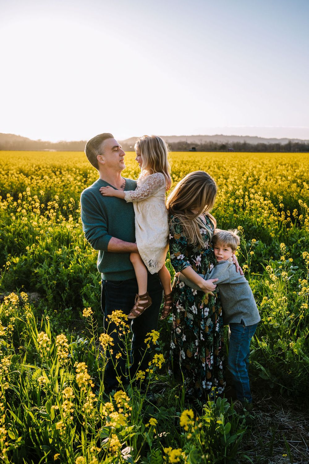 Sonoma County family photography spring session in the blooming mustard fields of wine country showing parents of their