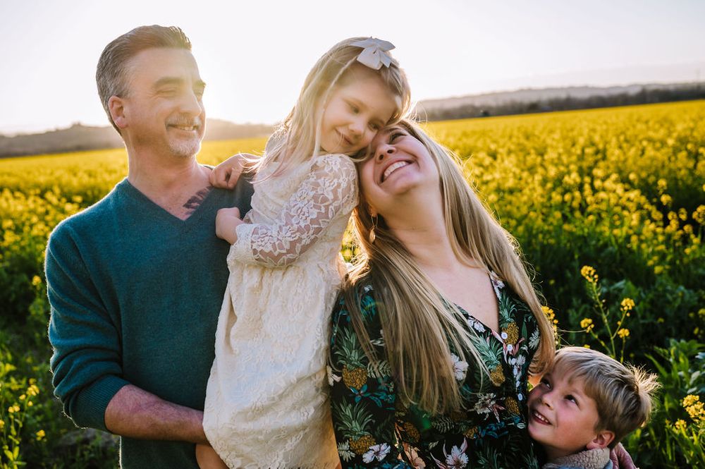 Sonoma County family photography spring session in the blooming mustard fields of wine country showing parents of their