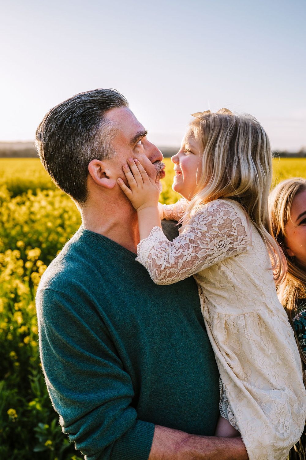 Sonoma County family photography spring session in the blooming mustard fields of wine country showing parents of their