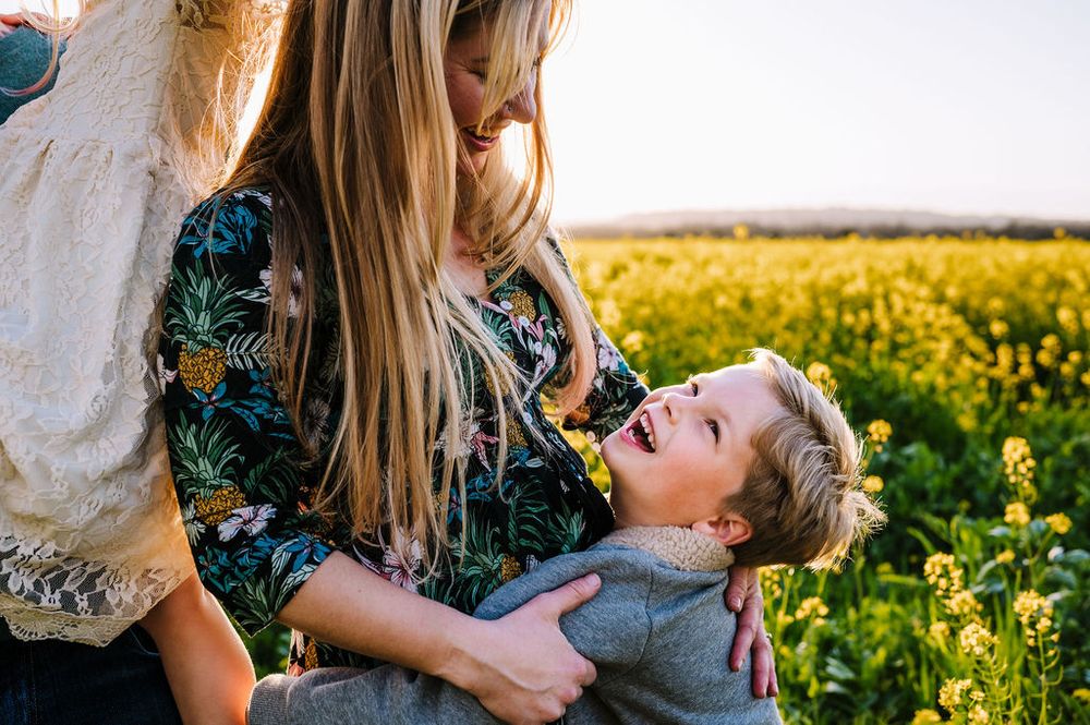 Sonoma County family photography spring session in the blooming mustard fields of wine country showing parents of their
