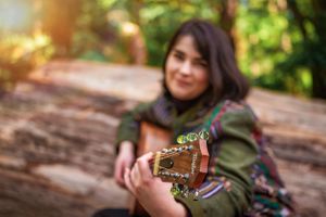 Artistic image of female singer with her guitar in Melbourne.