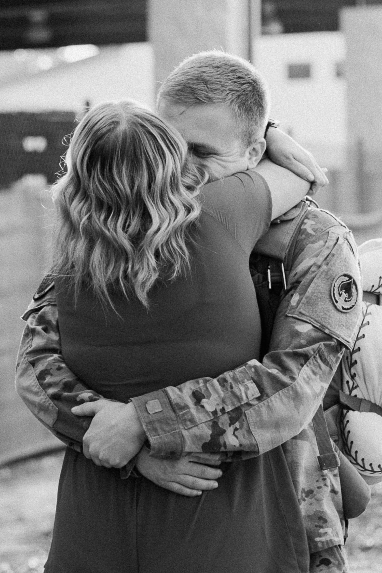 couple hugging tightly during their homecoming reunion
