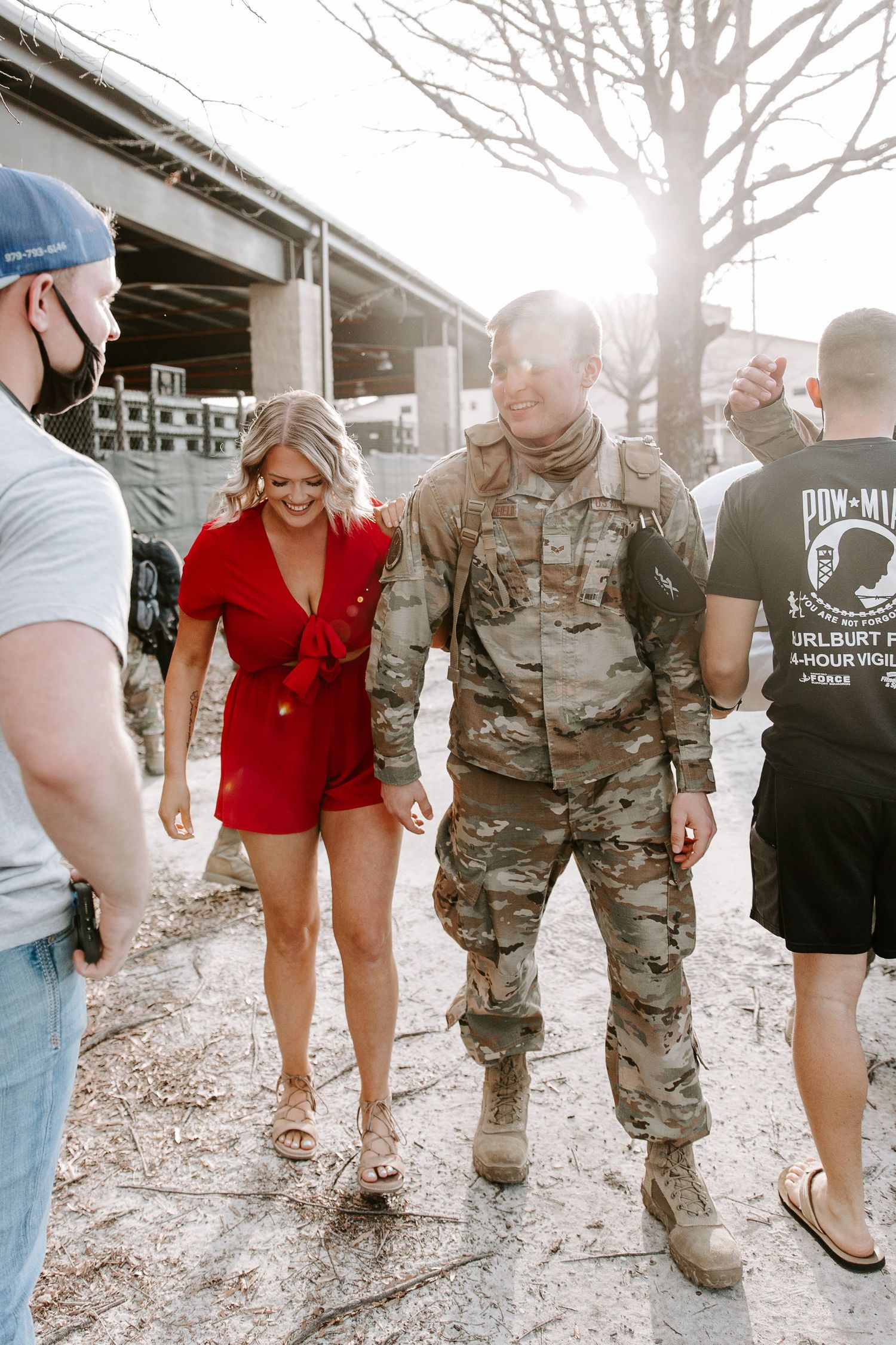woman and man walking and smiling right after their military homecoming reunion
