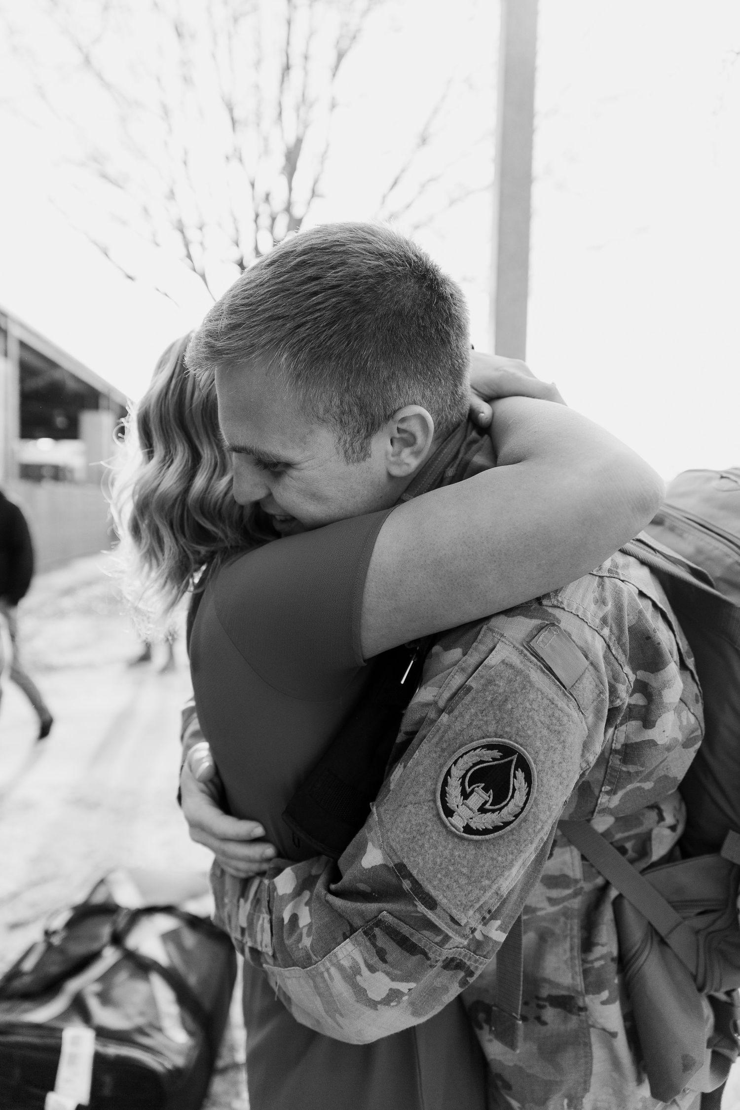 couple hugging each other tightly after not seeing each other for 6 months