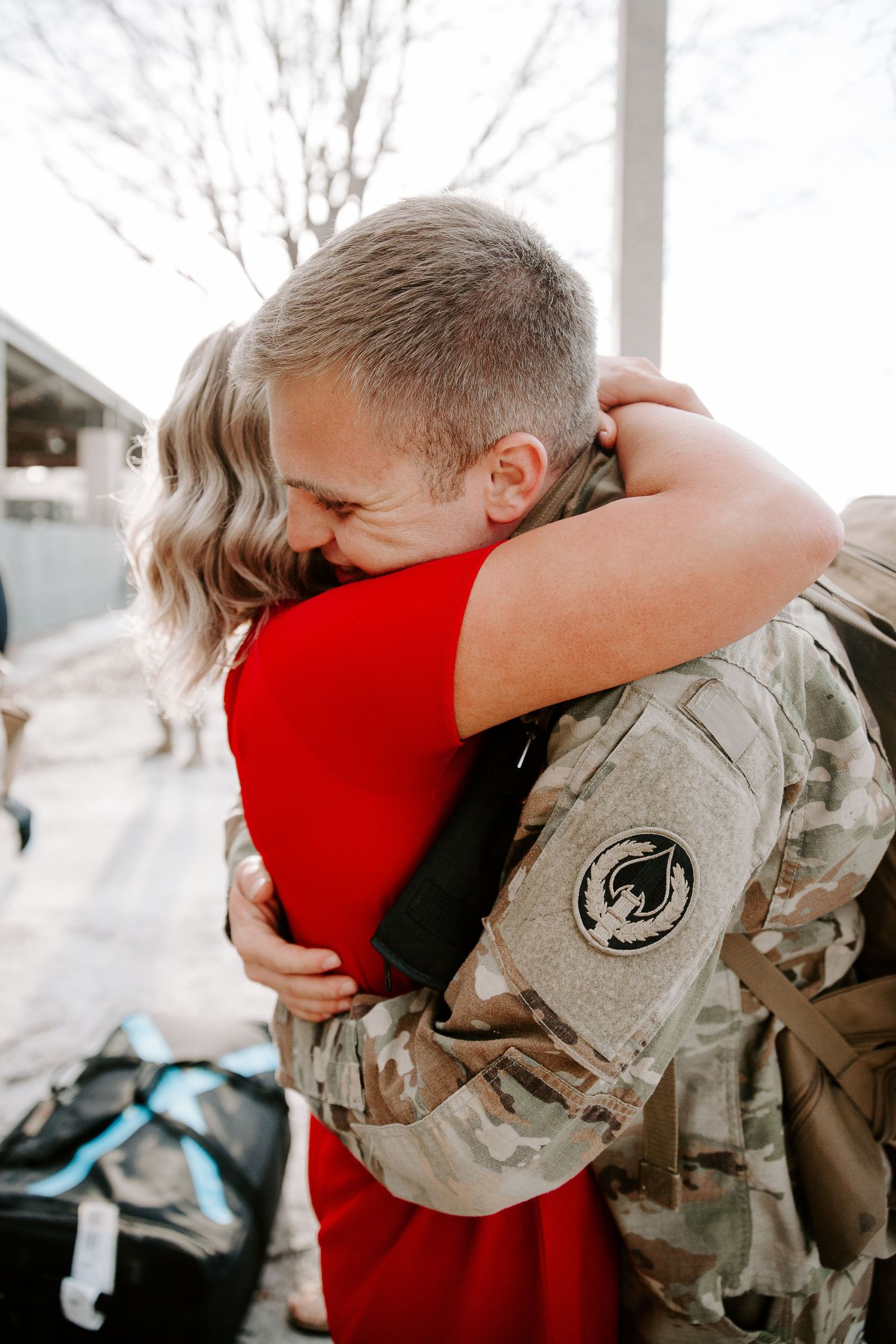 couple hugging during military homecoming