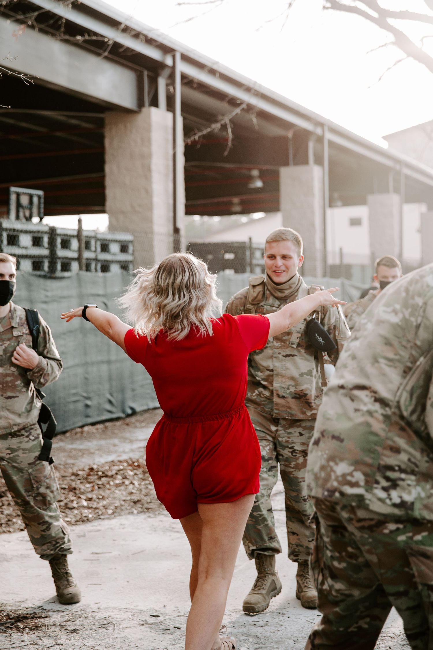 woman running to her husband during his homecoming
