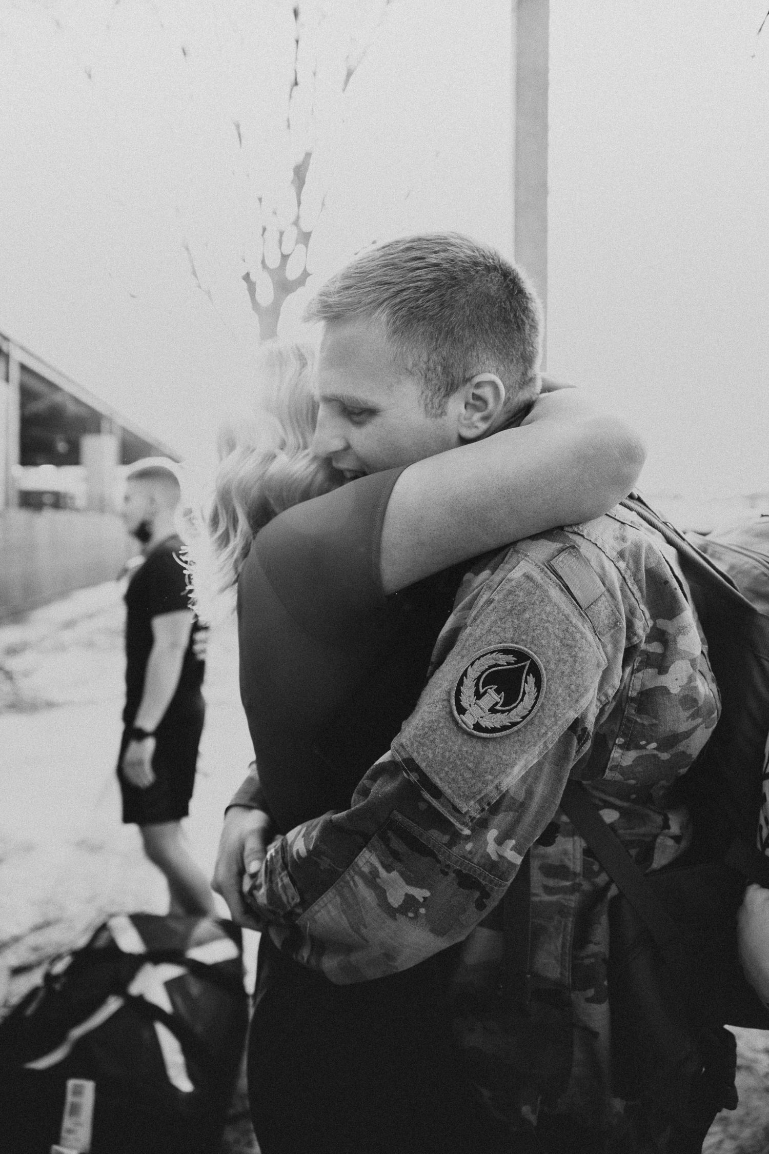 couple hugging each other tightly during the military homecoming