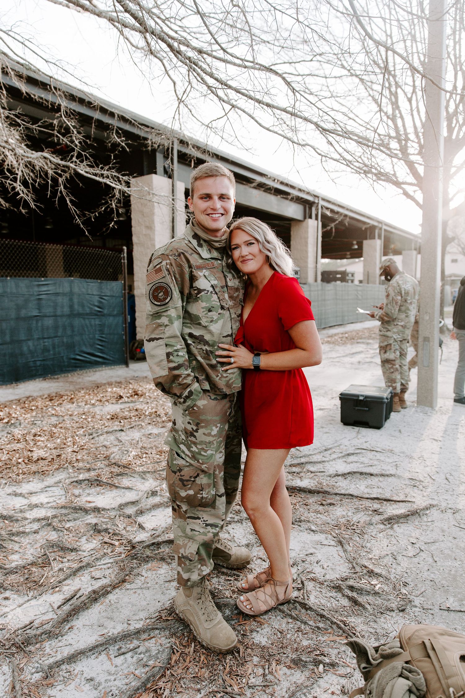 man and woman smiling with their arms around each other during his military homecoming