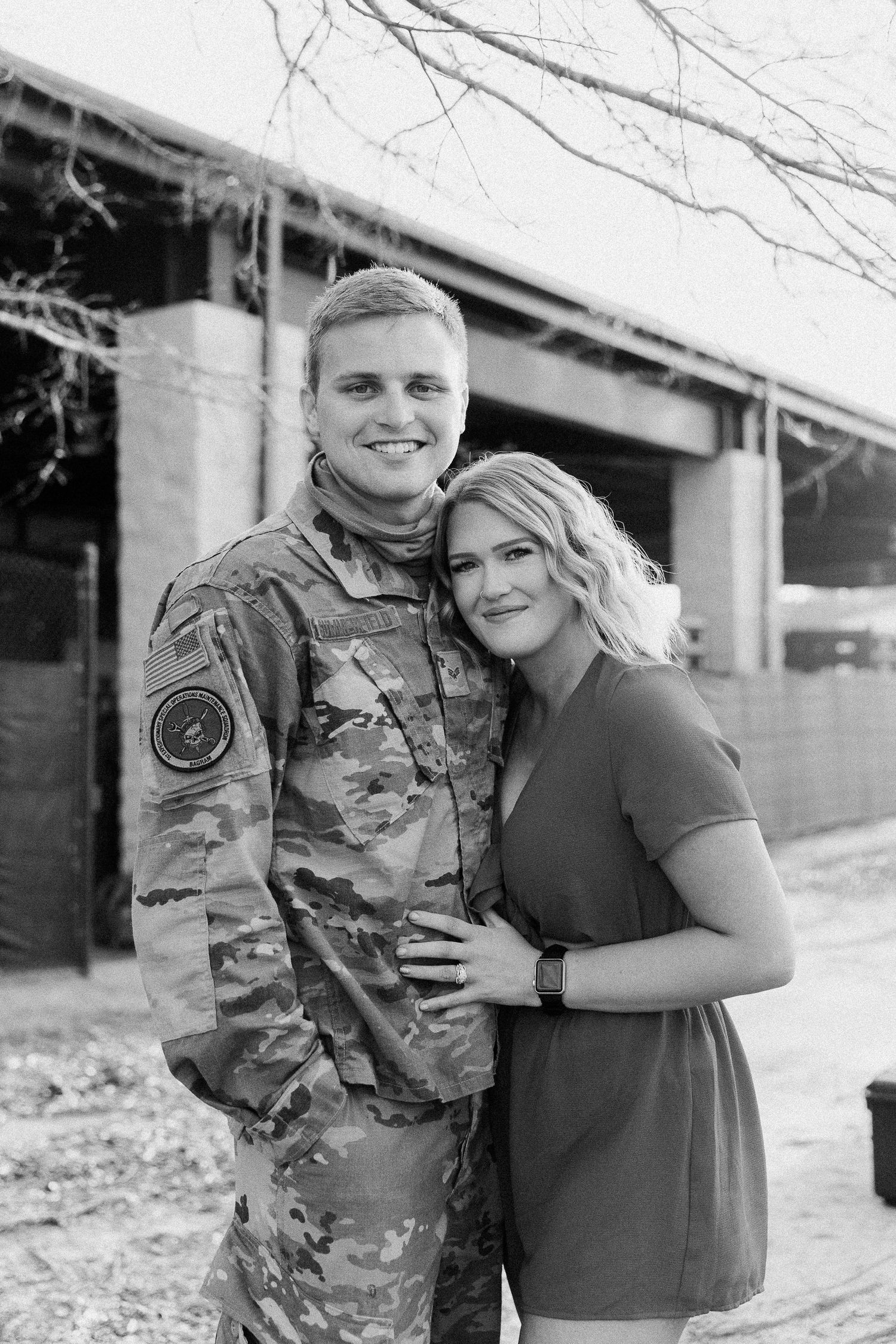 man and woman with their arms around each other smiling during his Air Force homecoming