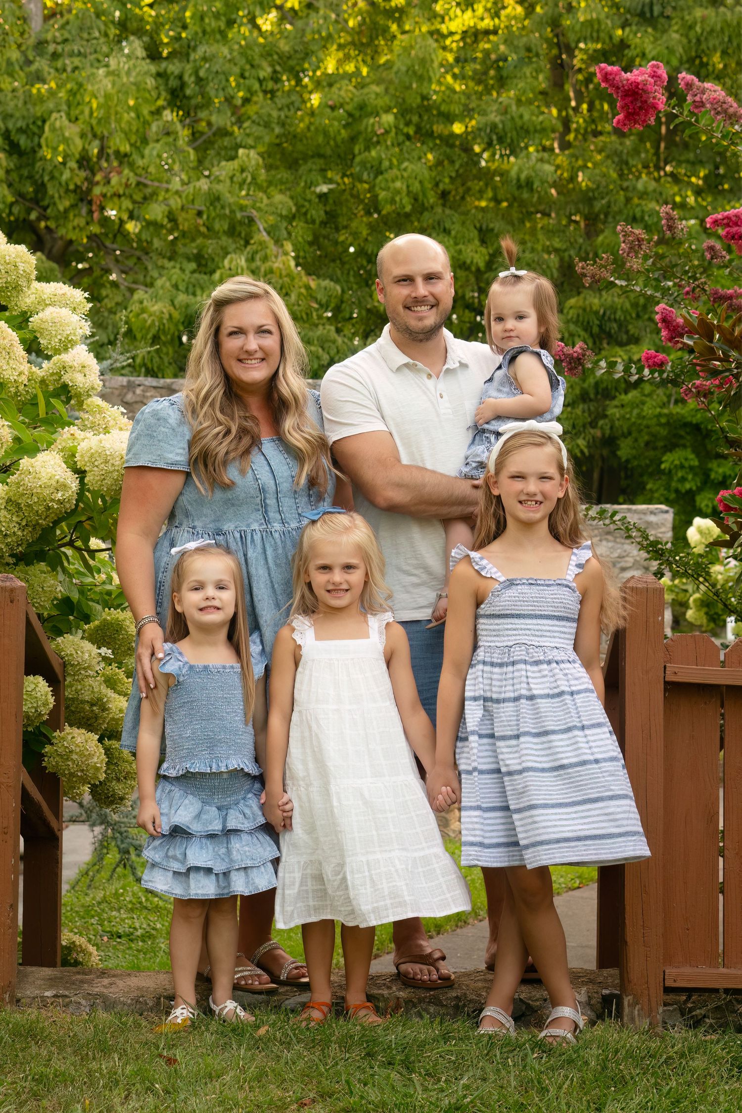 family smiles for portrait in Winchester, VA park