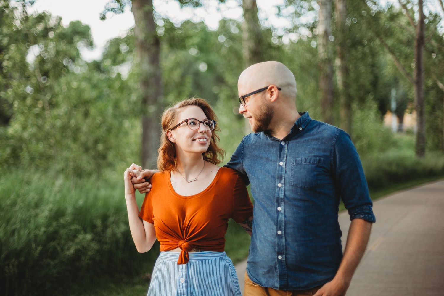 A couple walks along the path at Ross Natural Area during their portrait session in Fort Collins, Colorado.