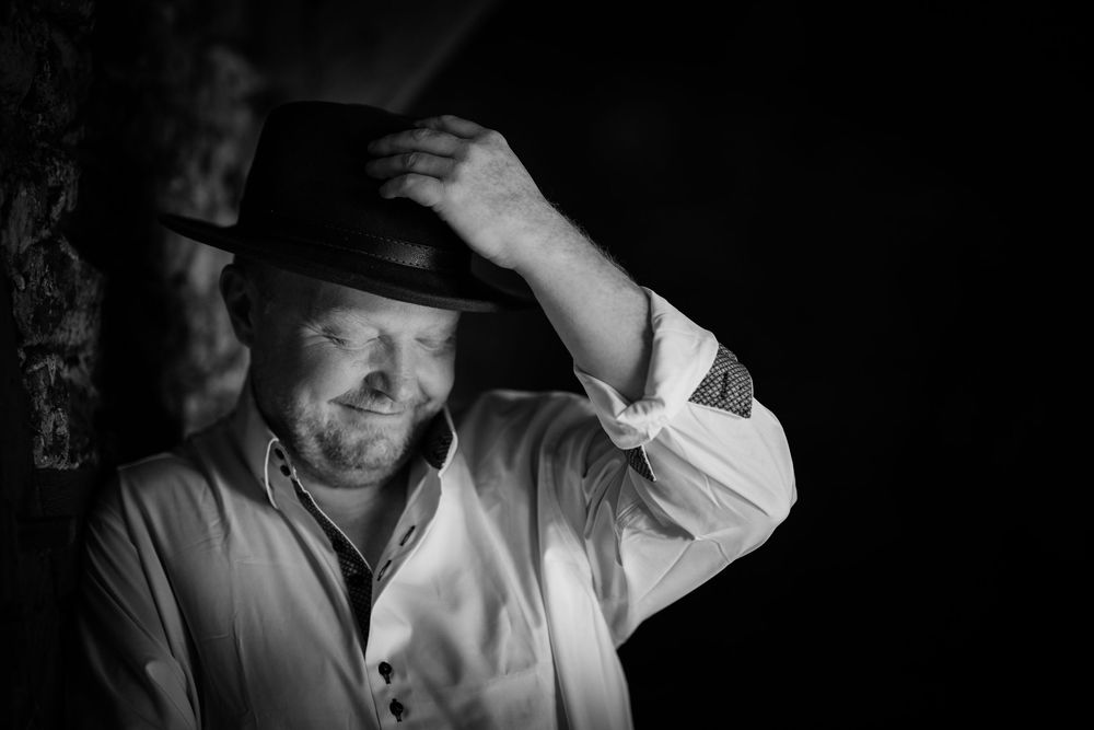 A black and white photo series showing candid emotional reactions across six moody portrait frames.
