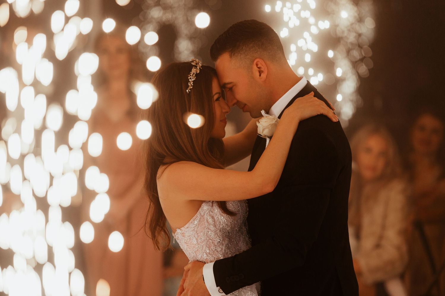 A romantic first dance with sparkling fireworks creating a magical backdrop.
