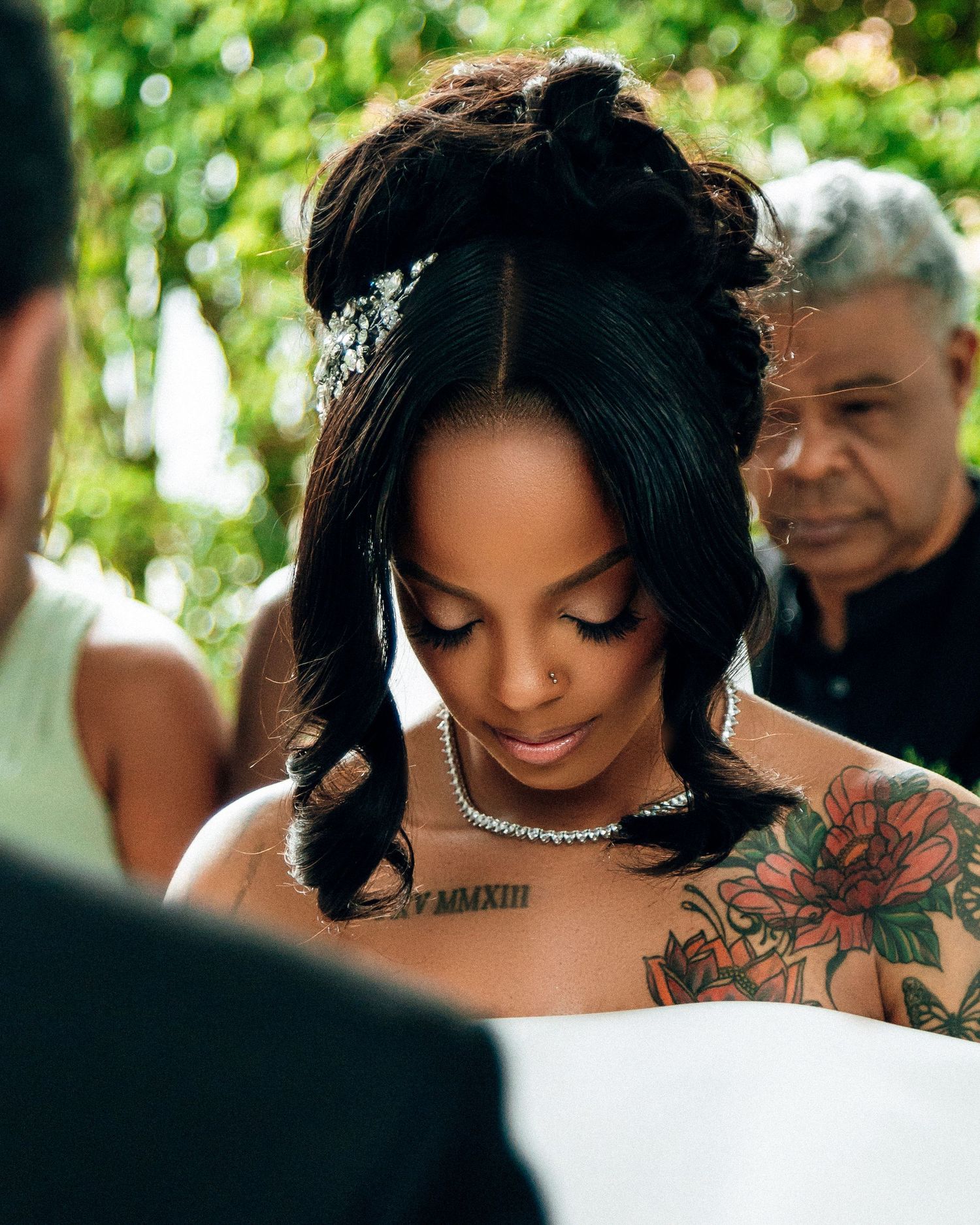 Close-up wedding day portrait showing intricate jewelry and floral details.