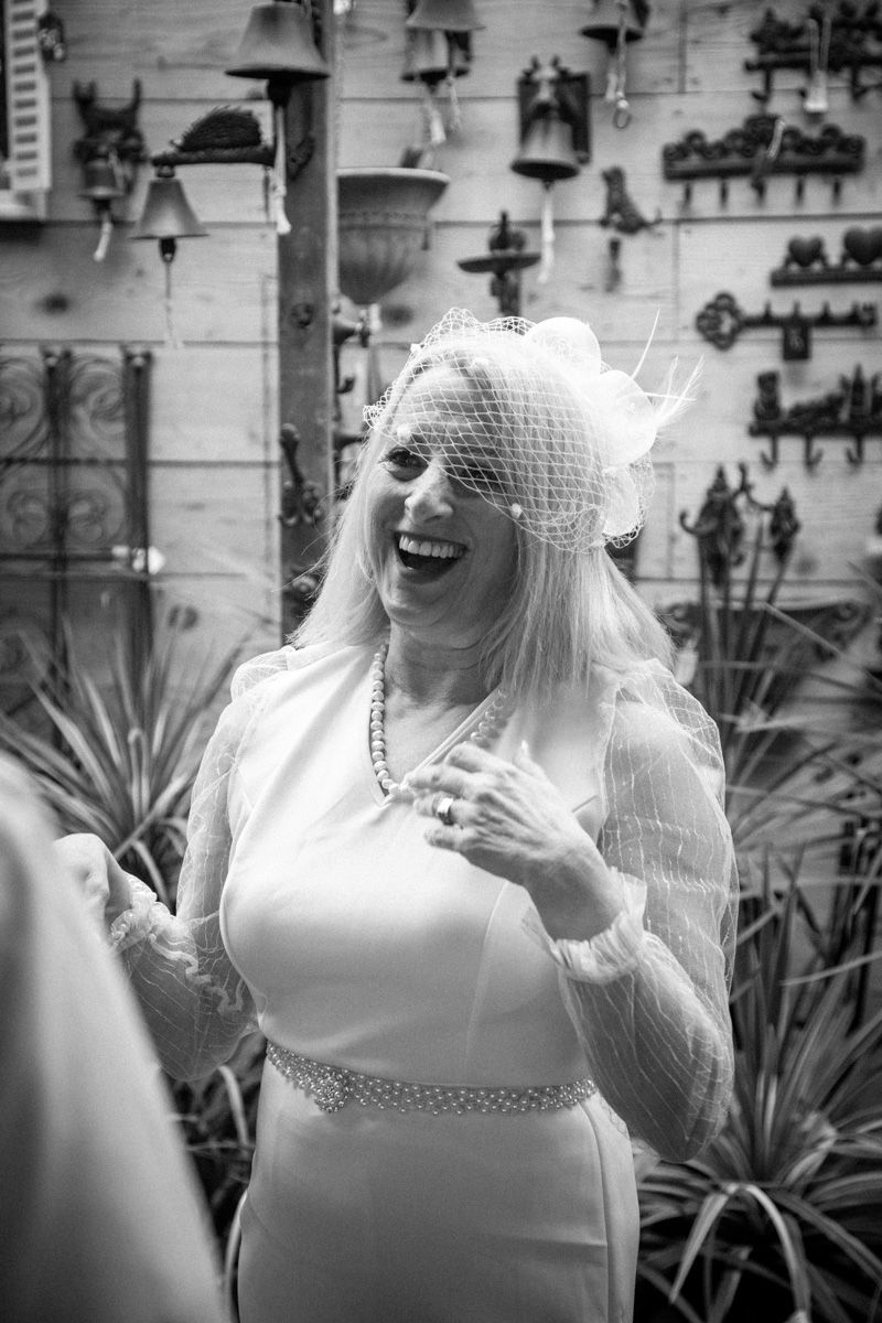 Black and white photo of joyful moment with decorative bells on wall.