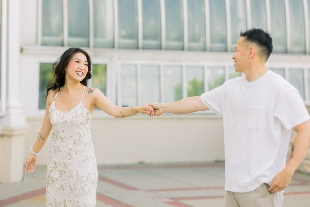 Playful dancing moment between couple at historic conservatory venue.