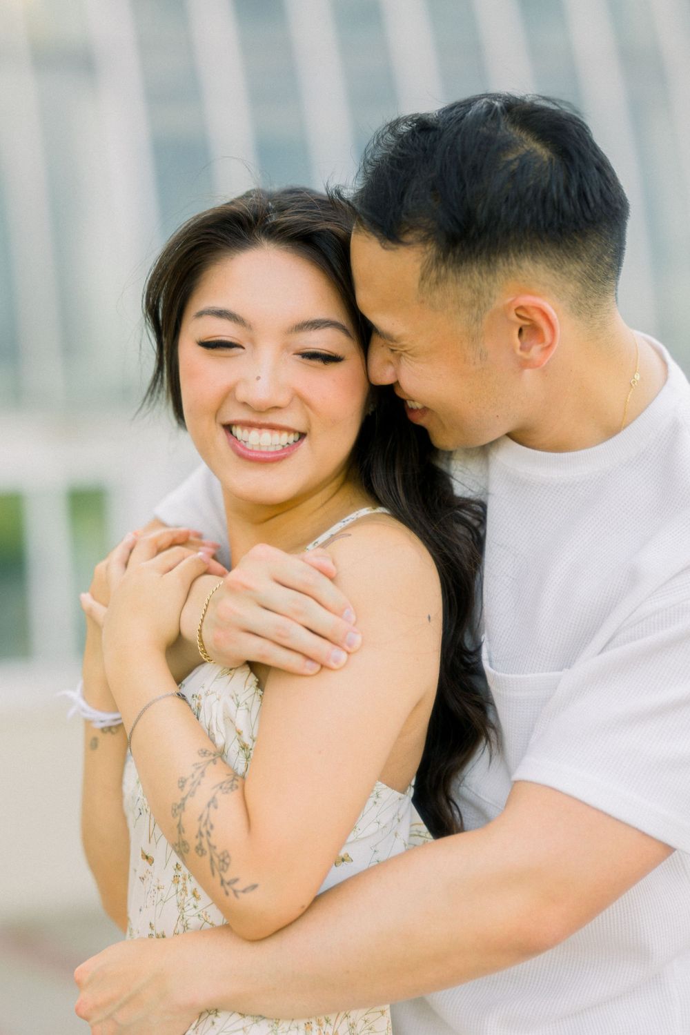 Joyful intimate moment shared between couple during outdoor photoshoot.