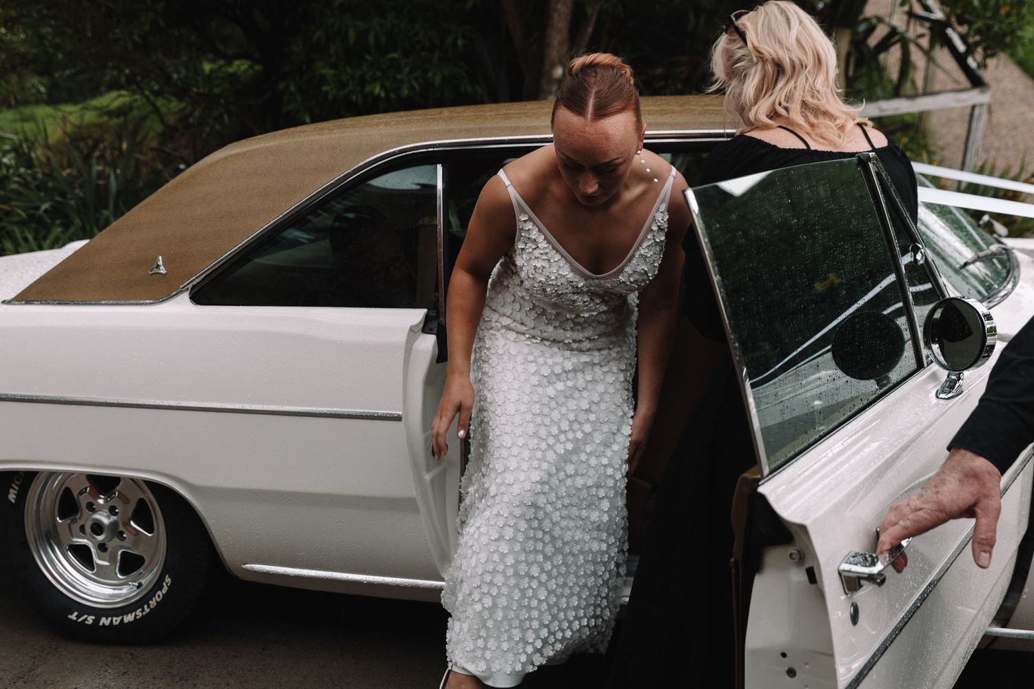 Classic white car with chrome details stands ready for a special occasion.