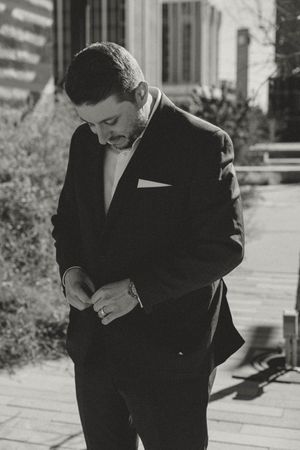 Series of black and white photos showing a gentleman in a dark suit checking his wristwatch while standing outdoors.
