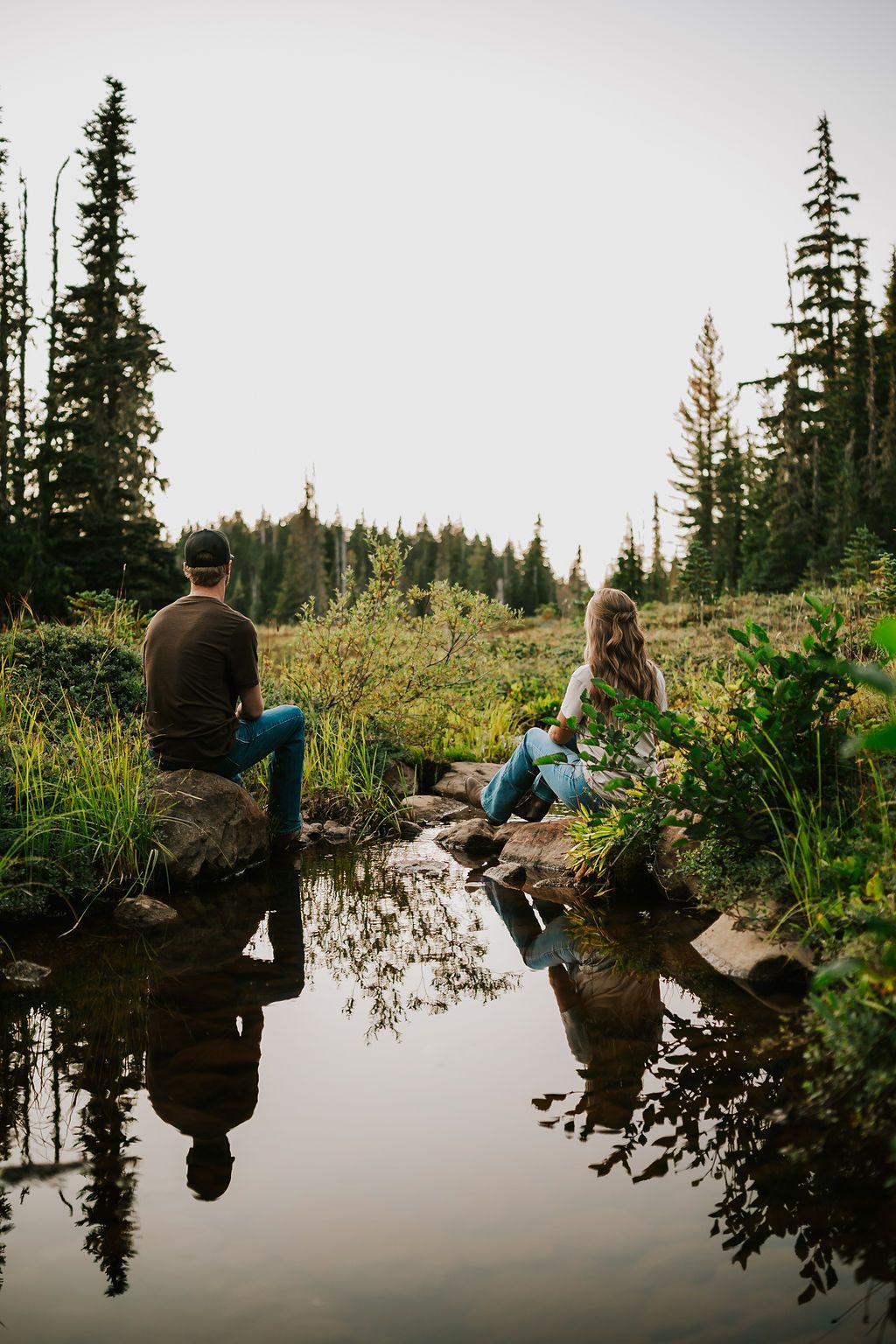 Couple sitting by stream in Paradise Meadows Mt Washington Vancouver Island. Photography by Photographer Soulfull Photographs