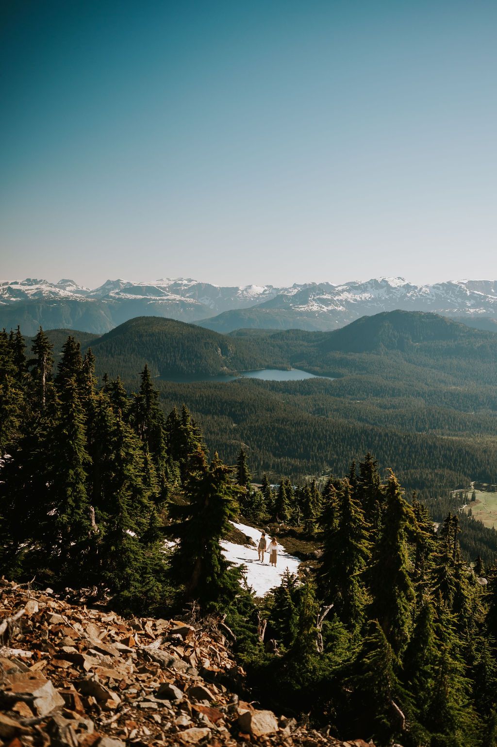 Adventure scenic photo couple on top of Mt Washington Vancouver Island with mountains. Photography by Photographer Soulfull Photographs