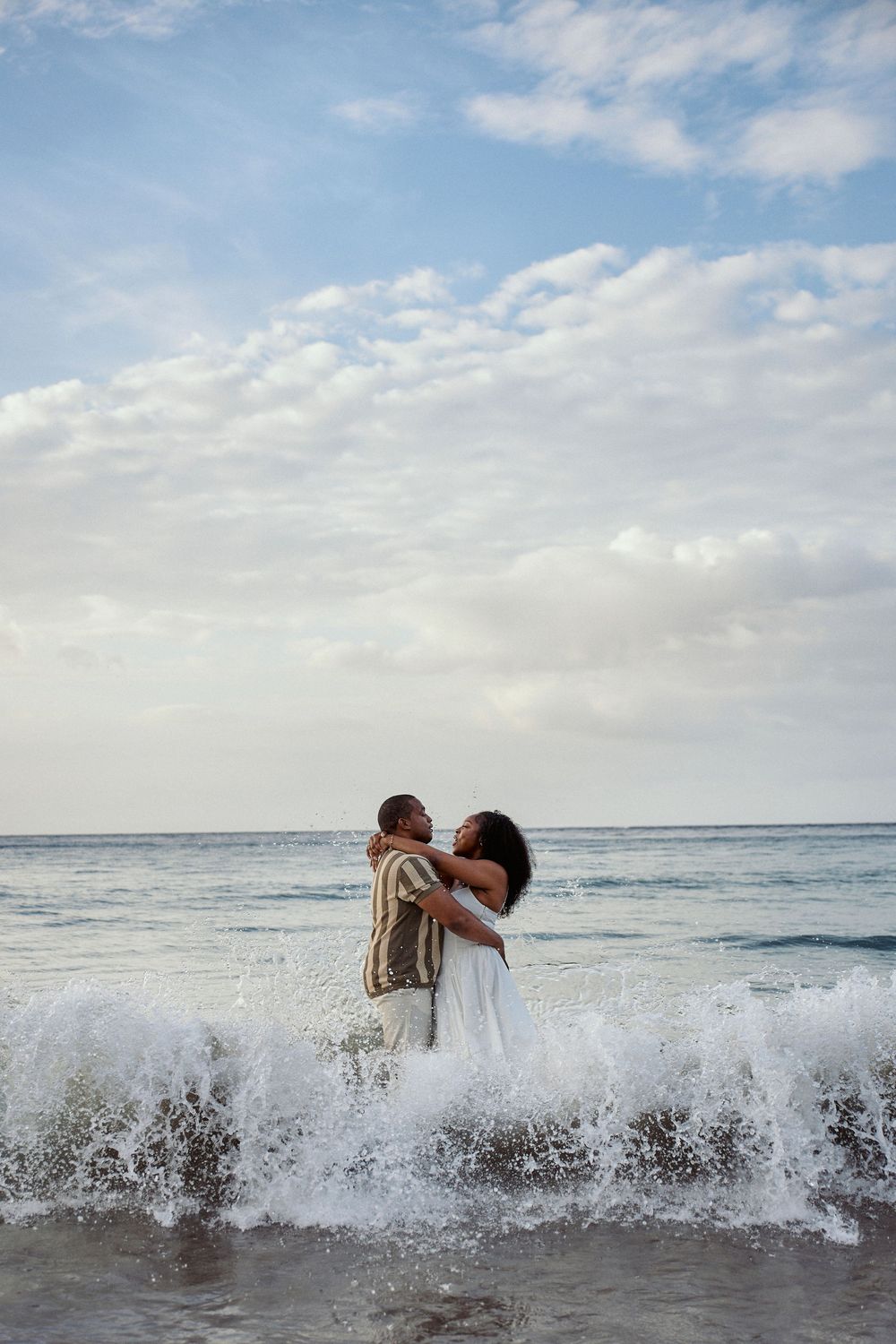 A sequence of photos shows a powerful ocean wave crashing and spraying over a beach Jamaican Photographer