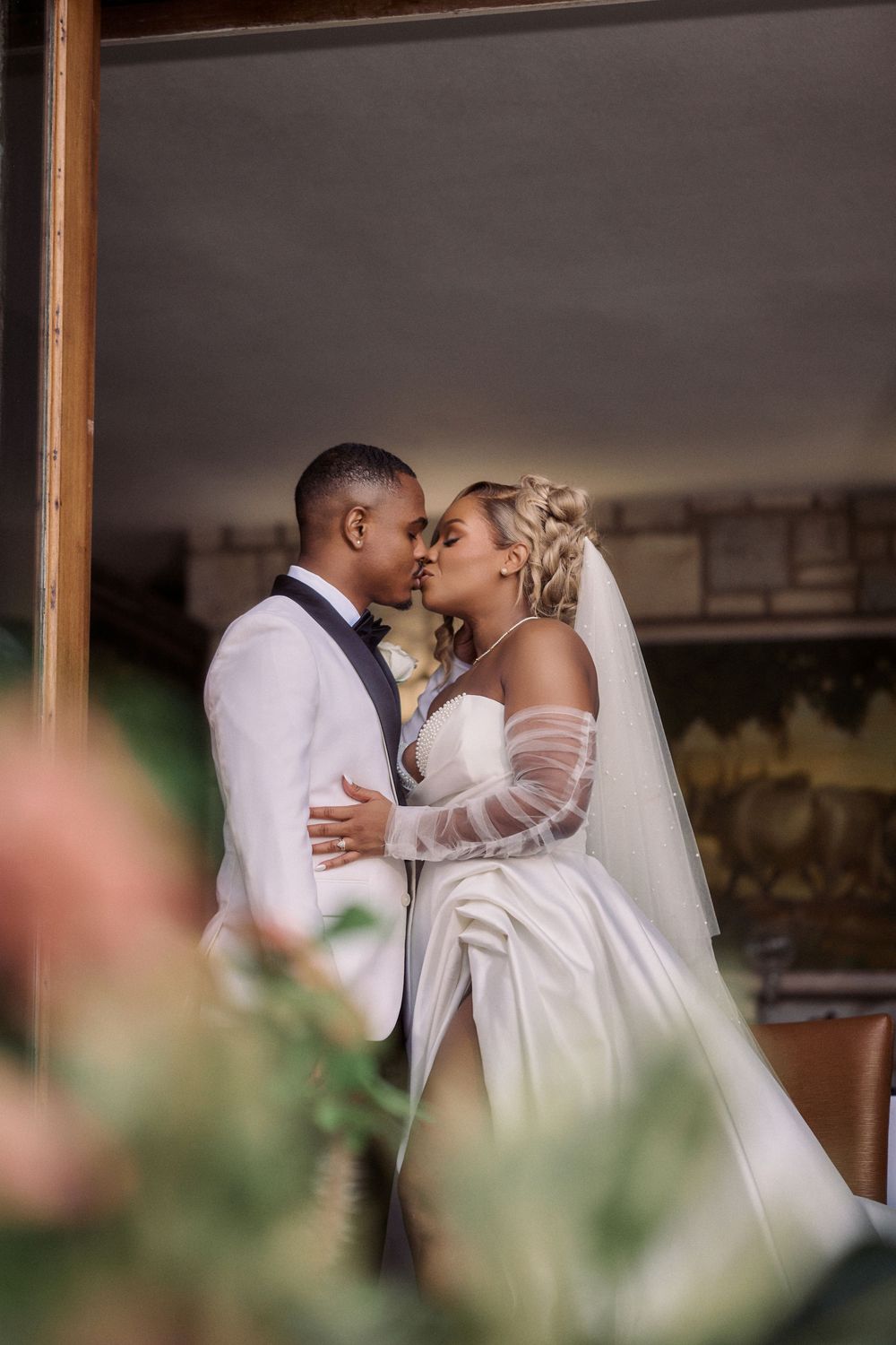 A romantic wedding moment captured as newlyweds embrace in formal attire with a flowing Jamaica Wedding Photographer