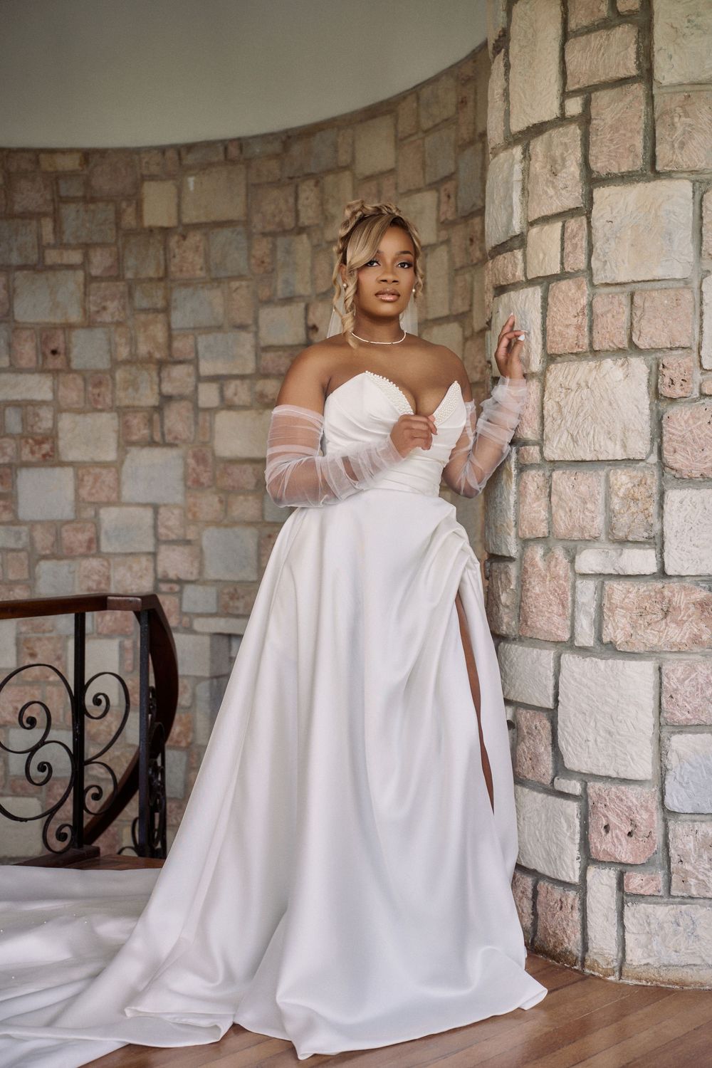Elegant white wedding gown features off-shoulder tulle sleeves and sweetheart neckline against Jamaica Wedding Photographer