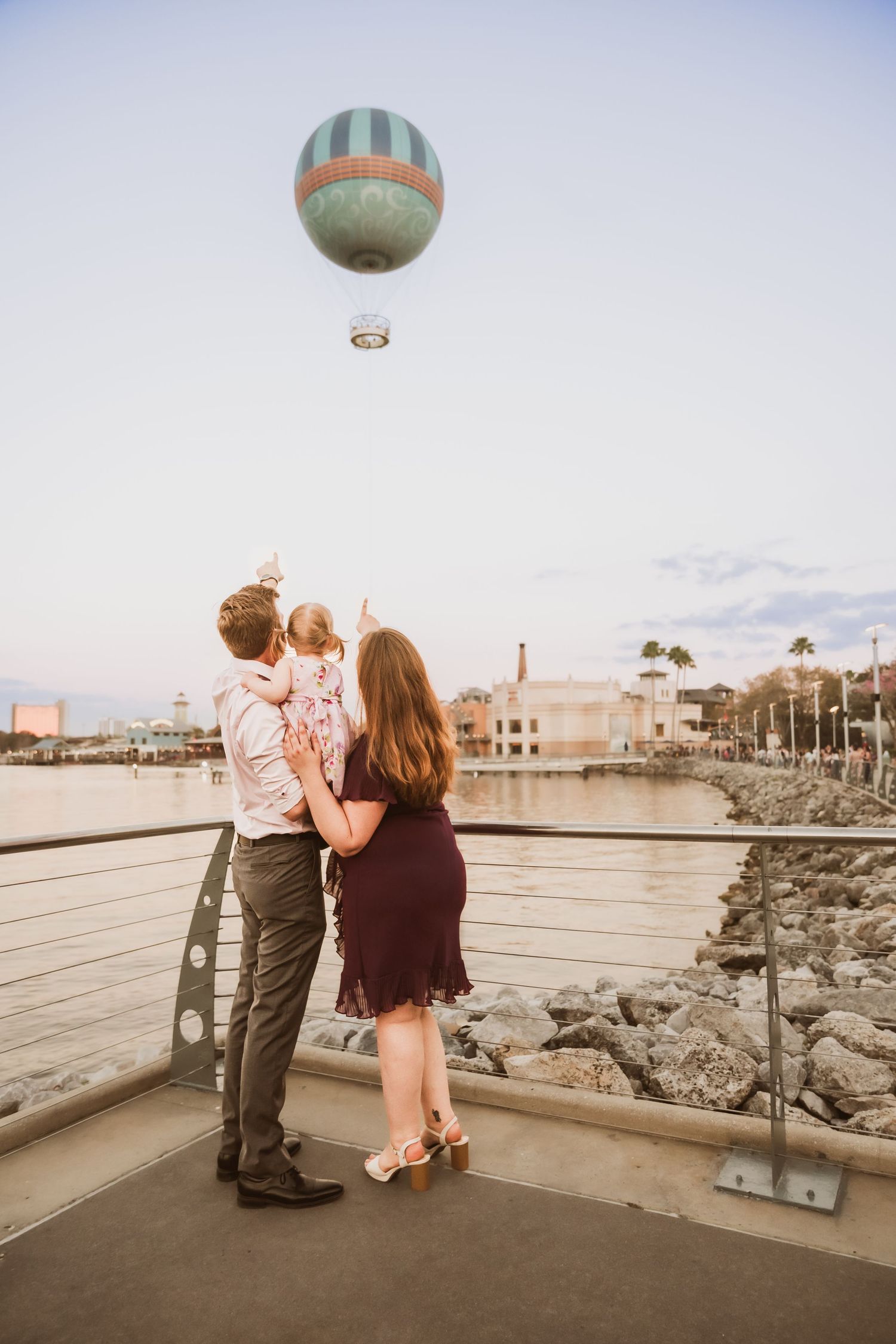 John & Emily anniversary photos at Disney Springs with baby Ripley, sunset in front of Aérophile. Cred: LexTakePix