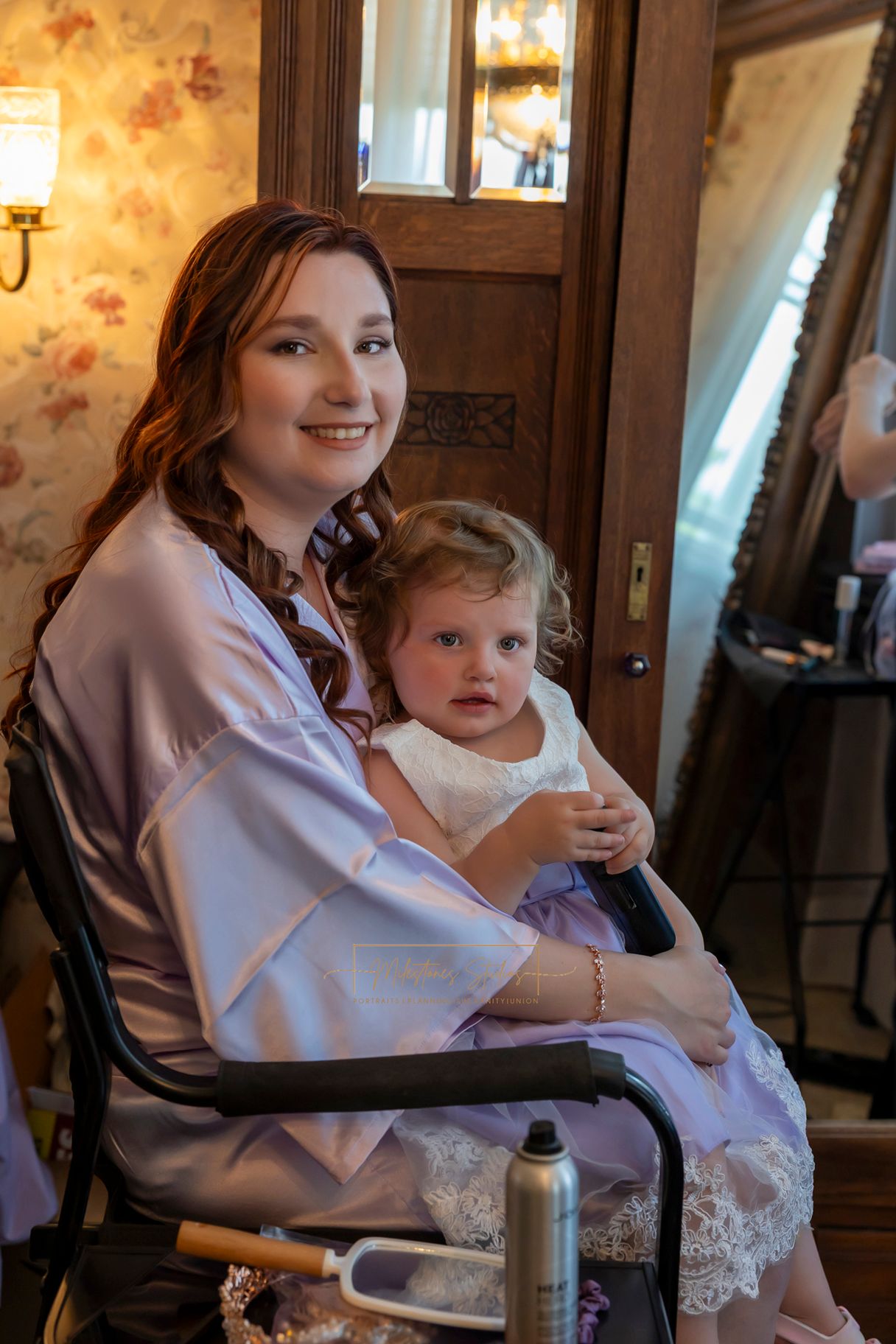 bride with 2-year-old daughter sitting in lap