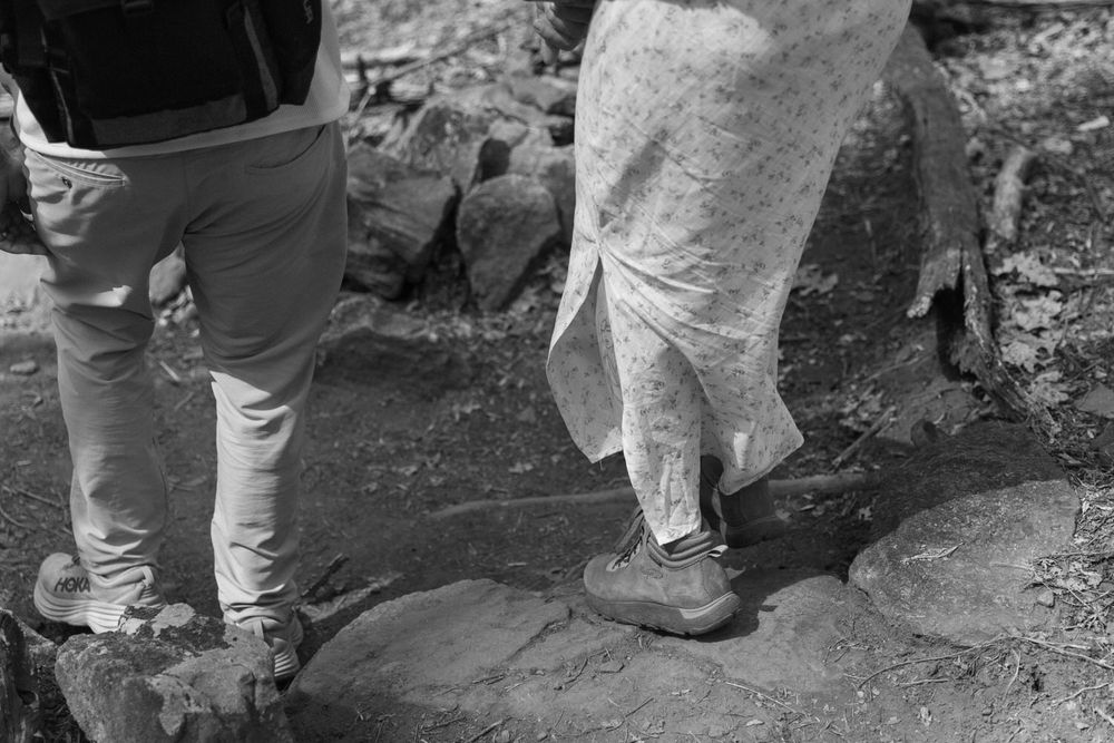 a close up of a newlywed bride and groom hiking down a mountain after their dahlonega elopement