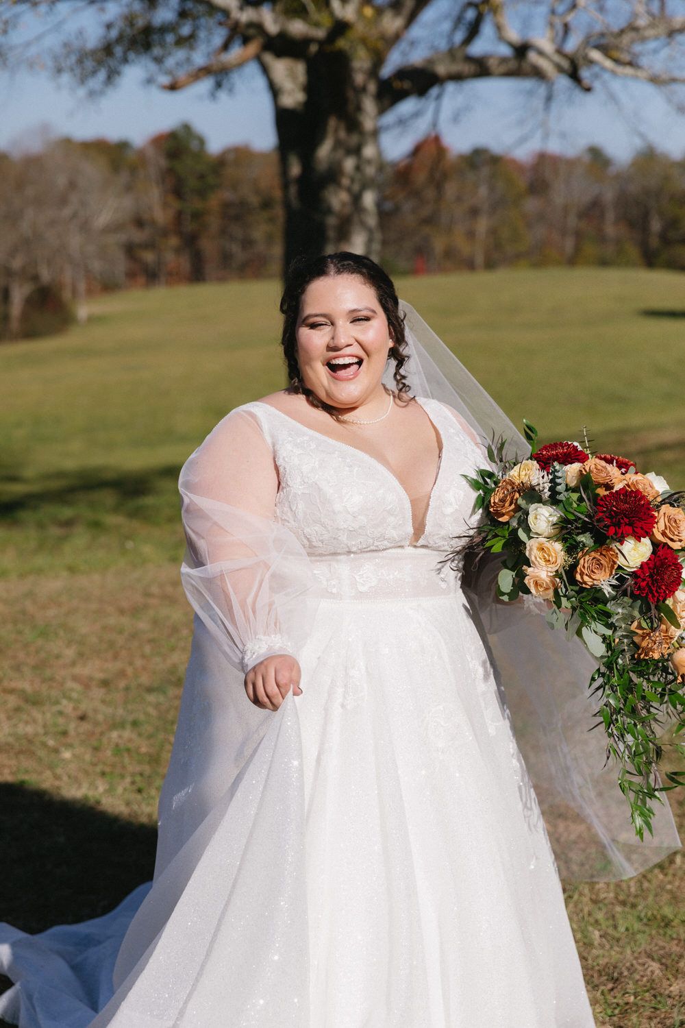 A radiant bride in a flowy wedding gown holds a bouquet on her asheville elopement day