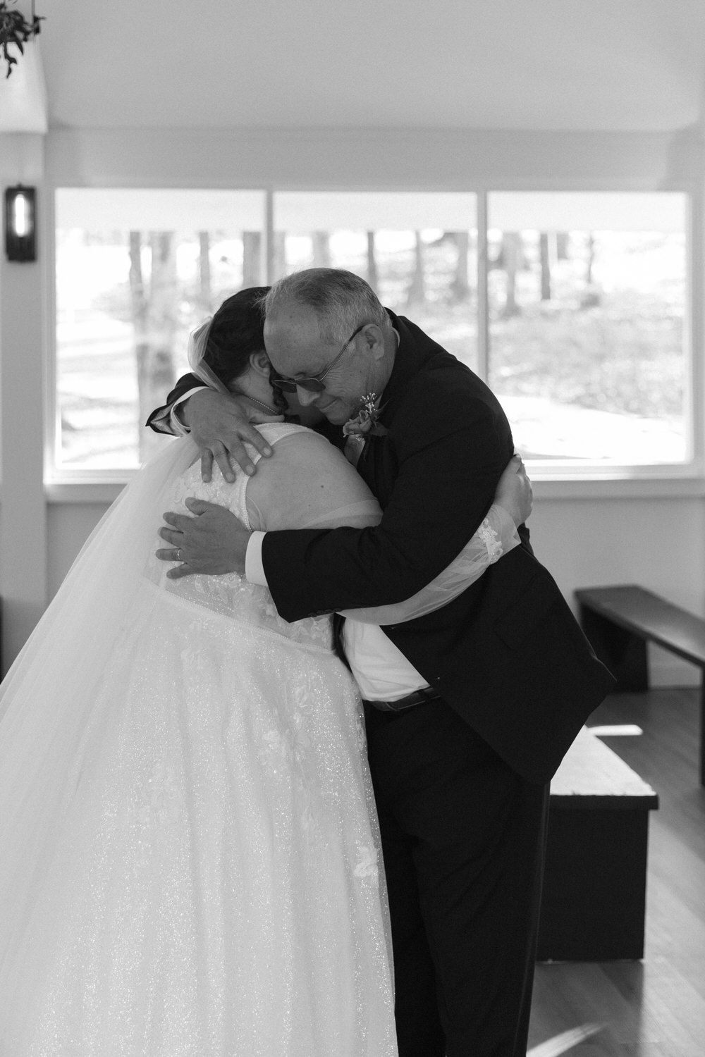 a bride and her father embrace during their first look on her asheville intimate wedding day