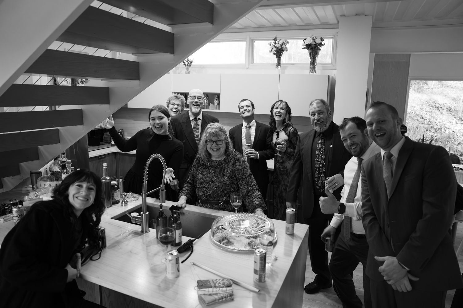 A group gathers around a table for a casual indoor celebration.