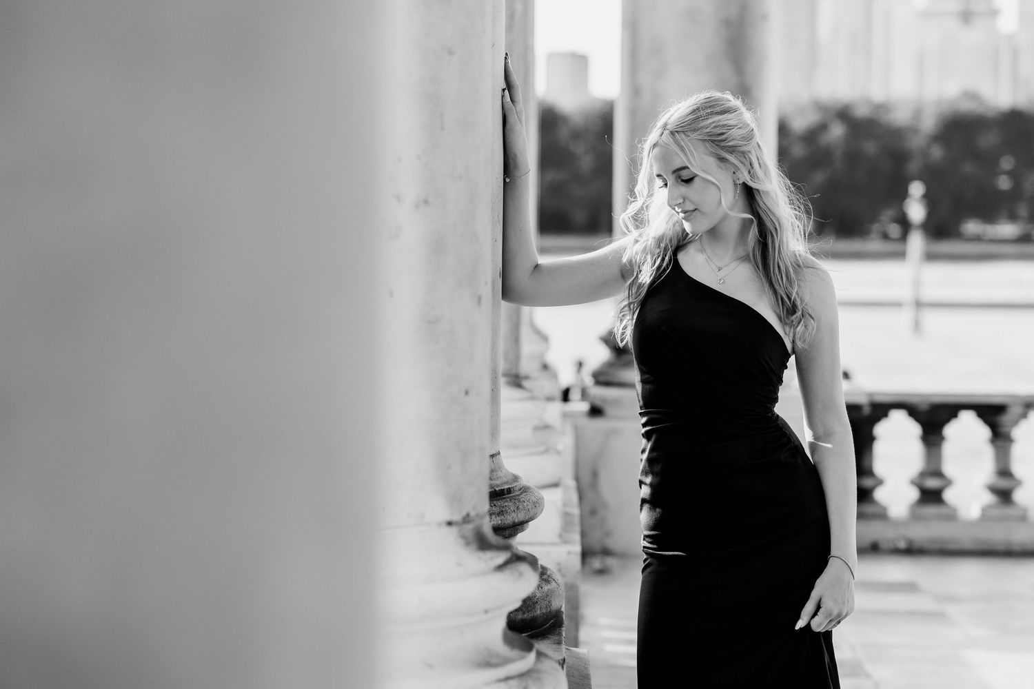 A collection of black and white wedding photographs showing romantic moments between newlyweds in outdoor settings.