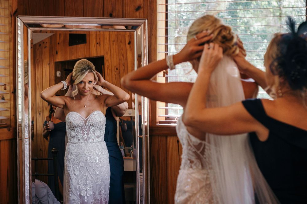 Getting ready scene inside a rustic wooden cabin with window lighting.