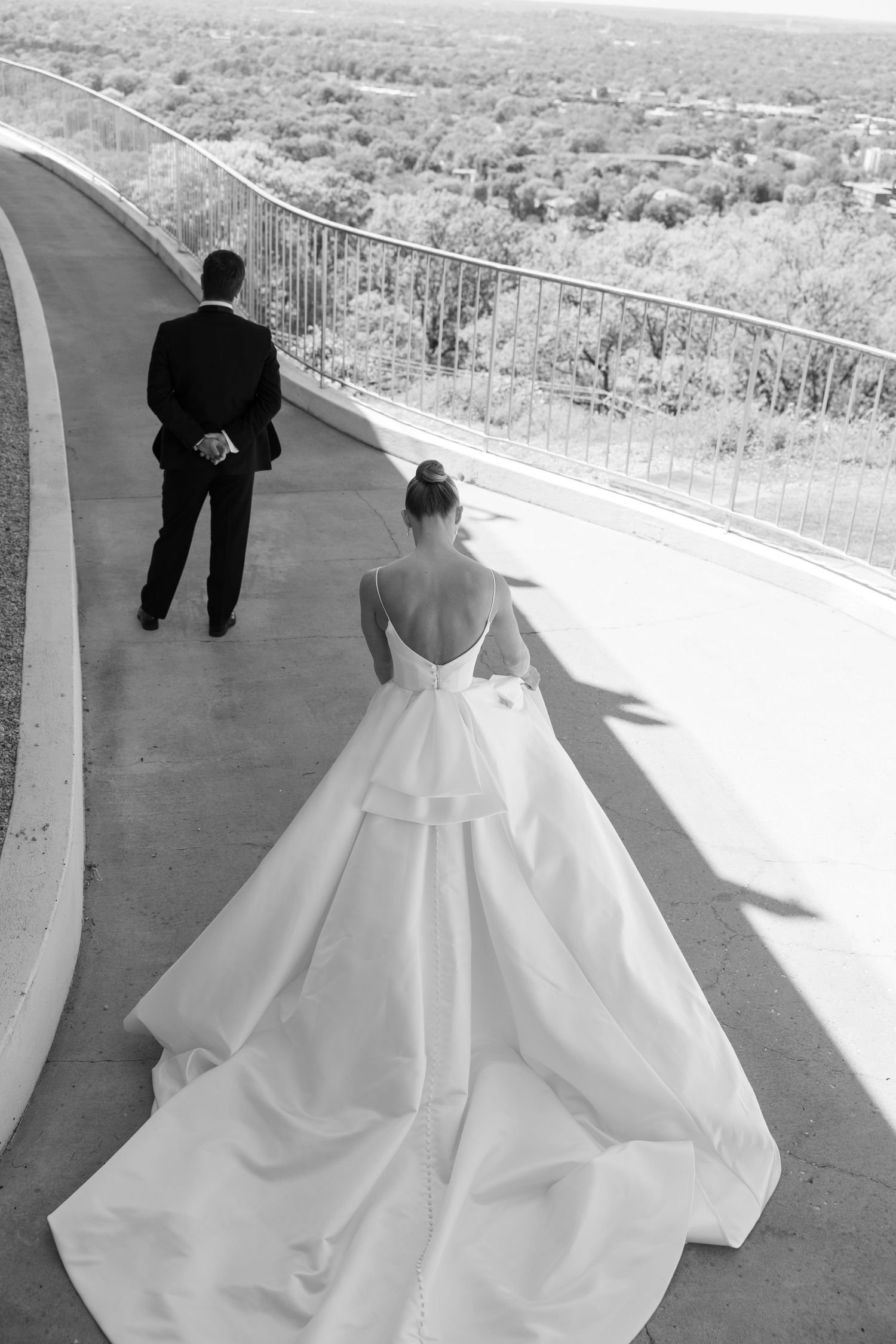 A series of wedding photos showing a couple in formal attire walking along a scenic outdoor balcony with a stunning vista.