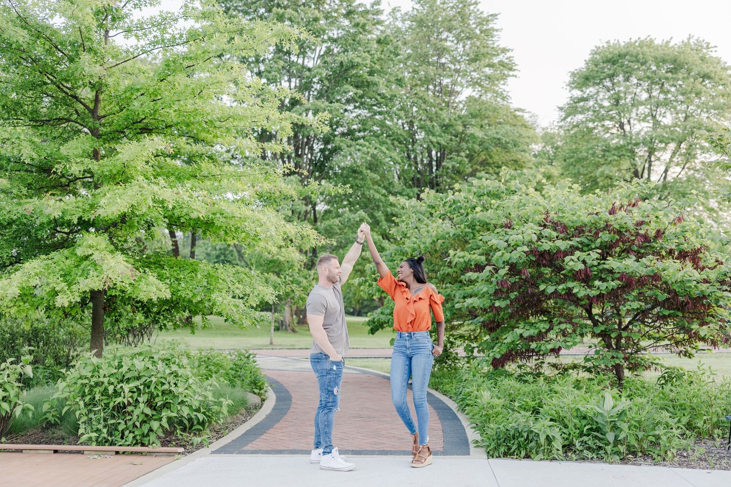 A series of seven photographs showing people walking through a lush green garden path with trees and vegetation.