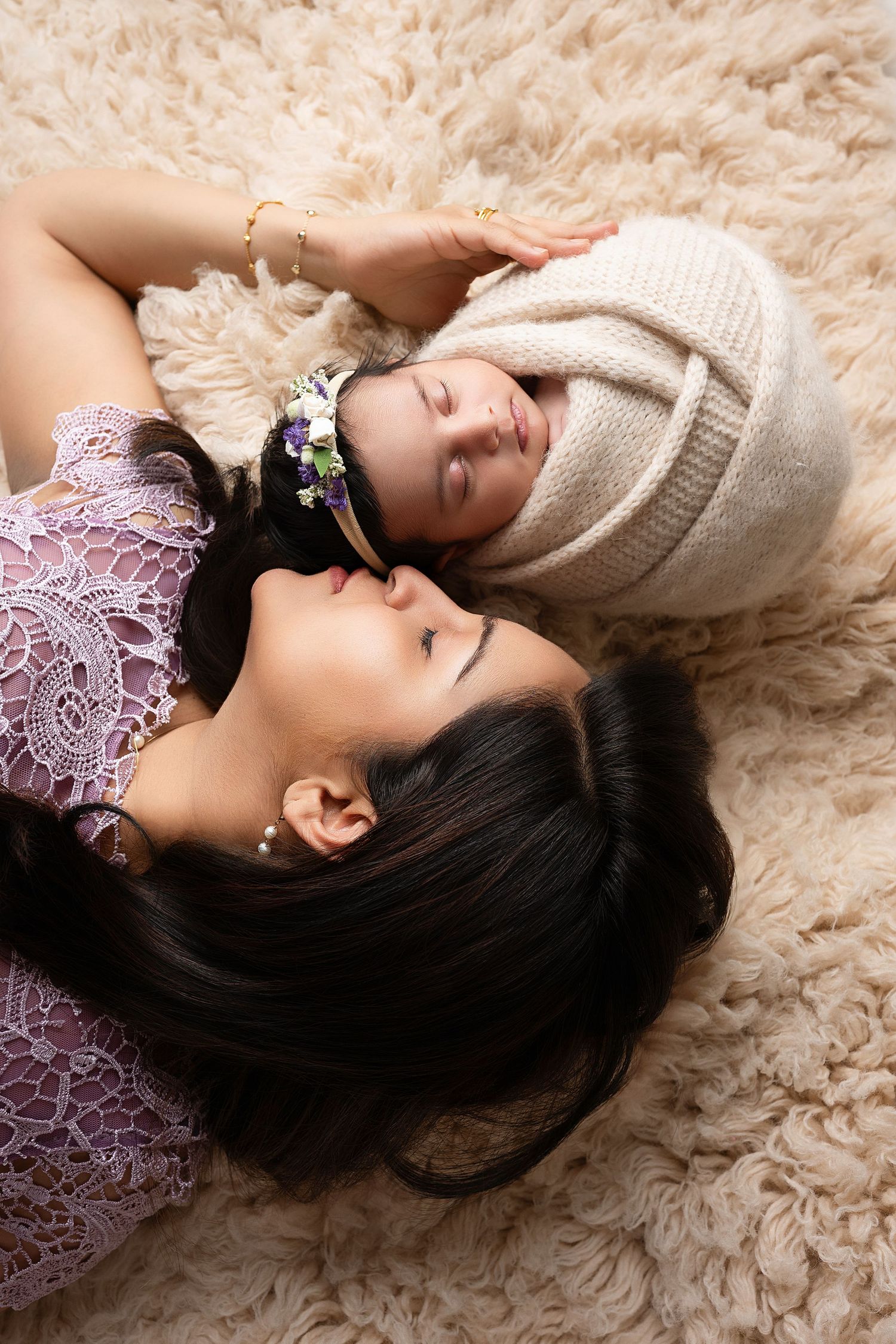 Dreamy portrait session on beige fur rug with lace details.