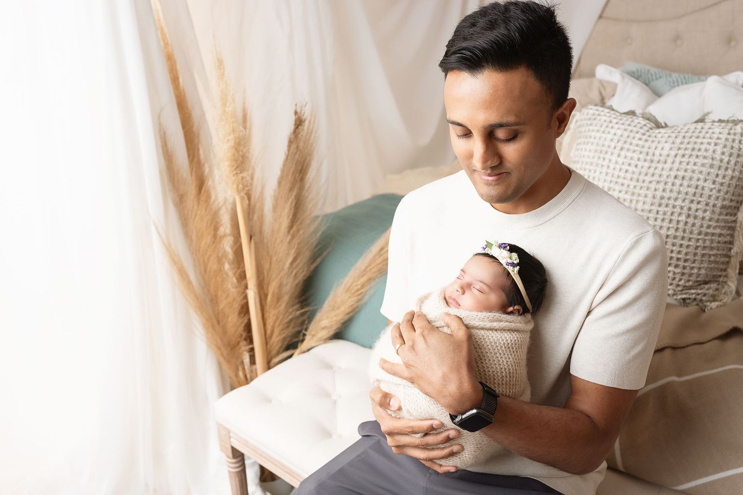 Modern family portrait session with minimalist white backdrop and natural poses.