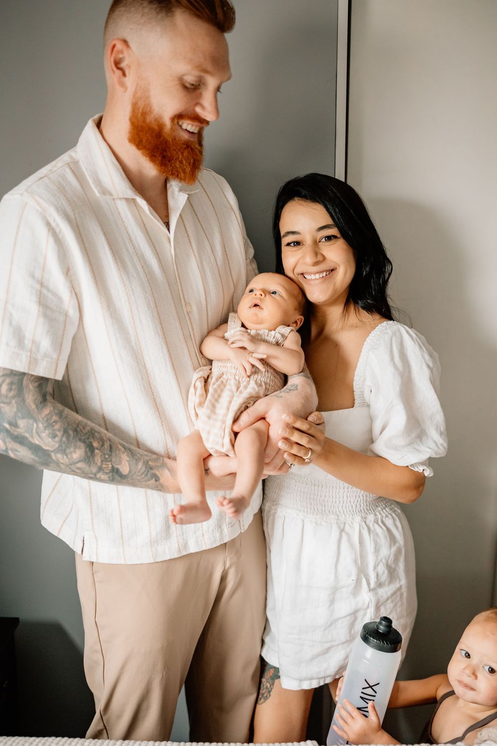 Series of intimate family moments showing parents in white clothing bonding with their infant child.