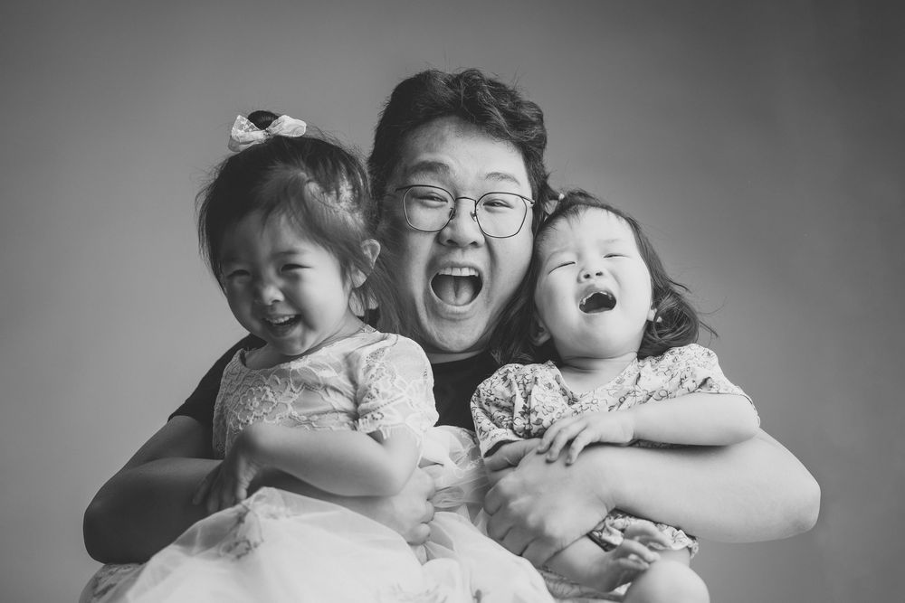 A black and white portrait capturing genuine laughter and joy.