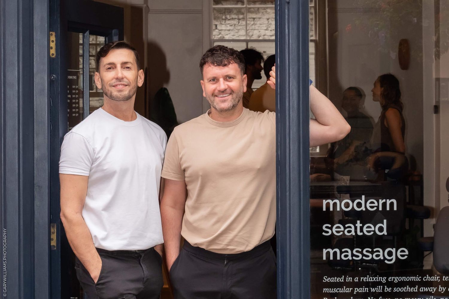Modern massage therapy business storefront with signage and doorway.
