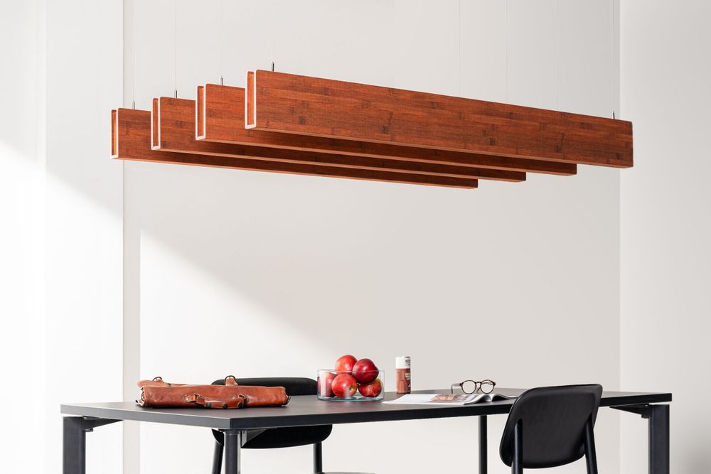 Modern dining area with a sleek black table and geometric copper lighting fixture suspended from the ceiling.
