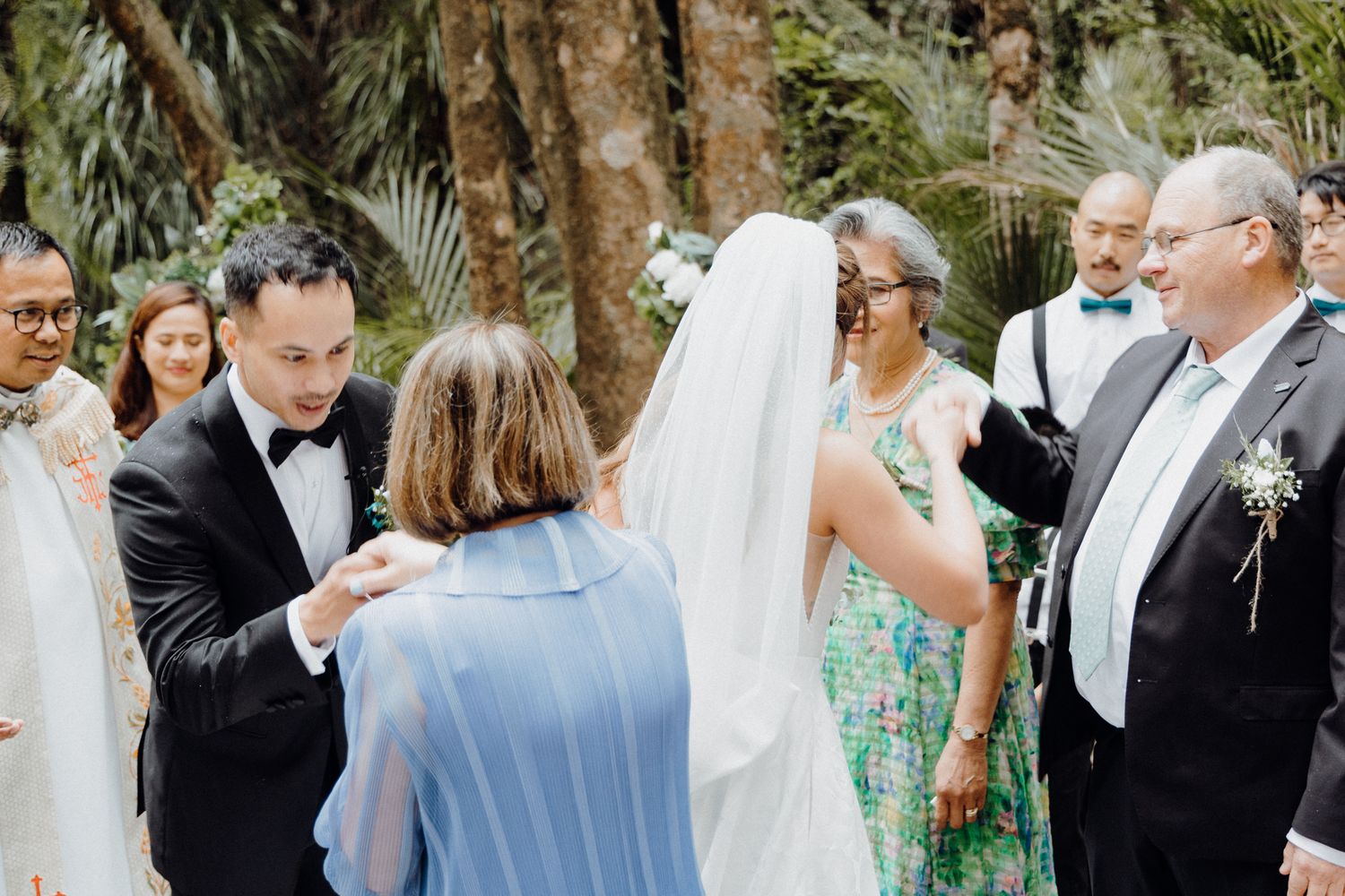 The bride and groom pay their respects to their parents captured by Apertured Media Auckland Wedding Photographer.